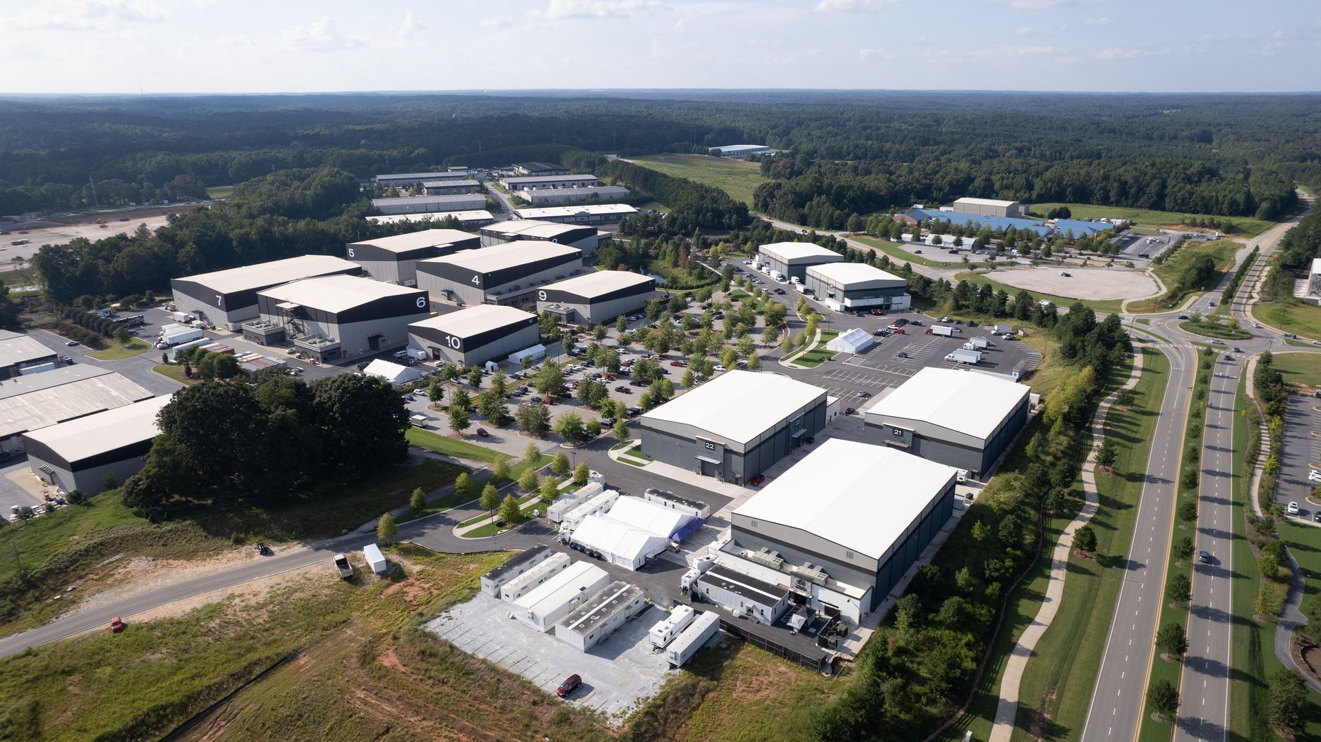 An aerial view of a large industrial area with lots of buildings and trees.