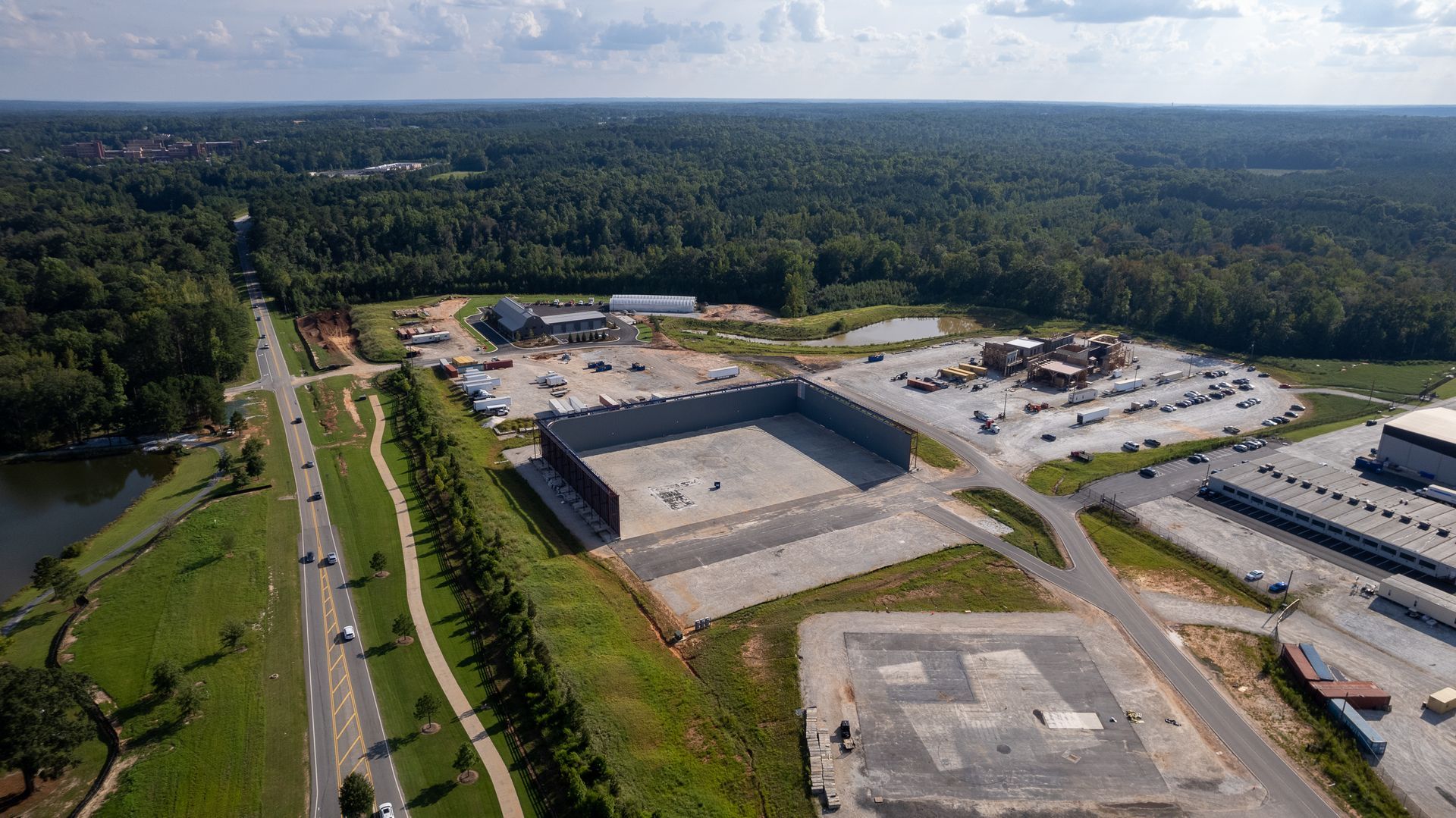An aerial view of a large industrial area with a helicopter pad in the middle.