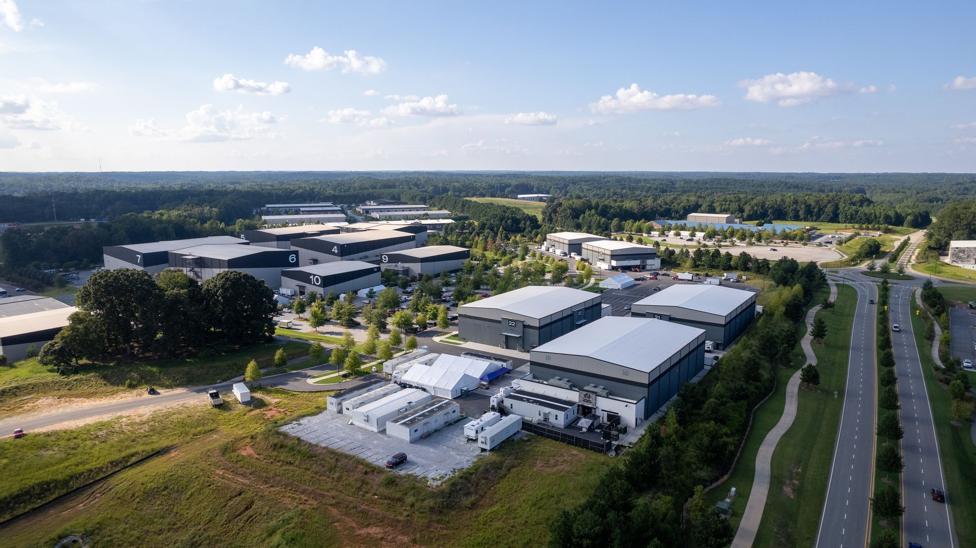 An aerial view of a large industrial area with lots of buildings and a highway.