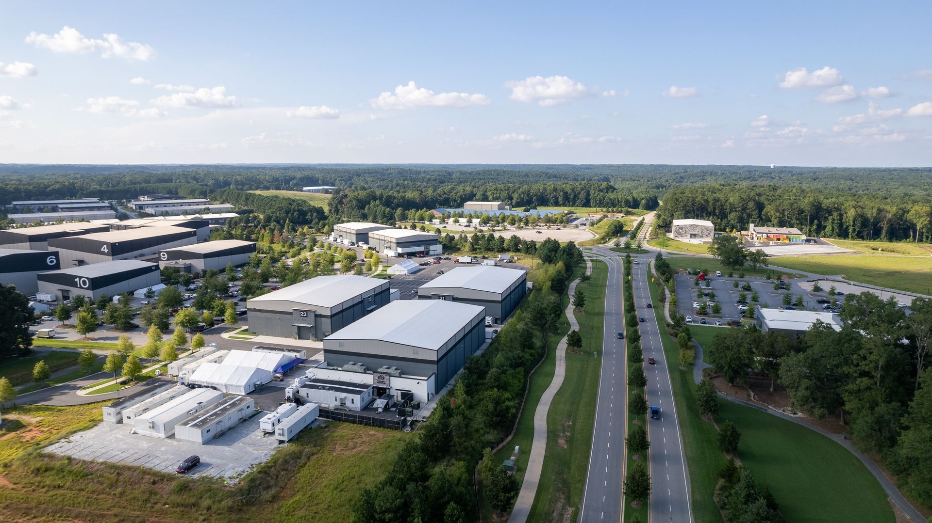 An aerial view of a large industrial area with lots of buildings and a highway.