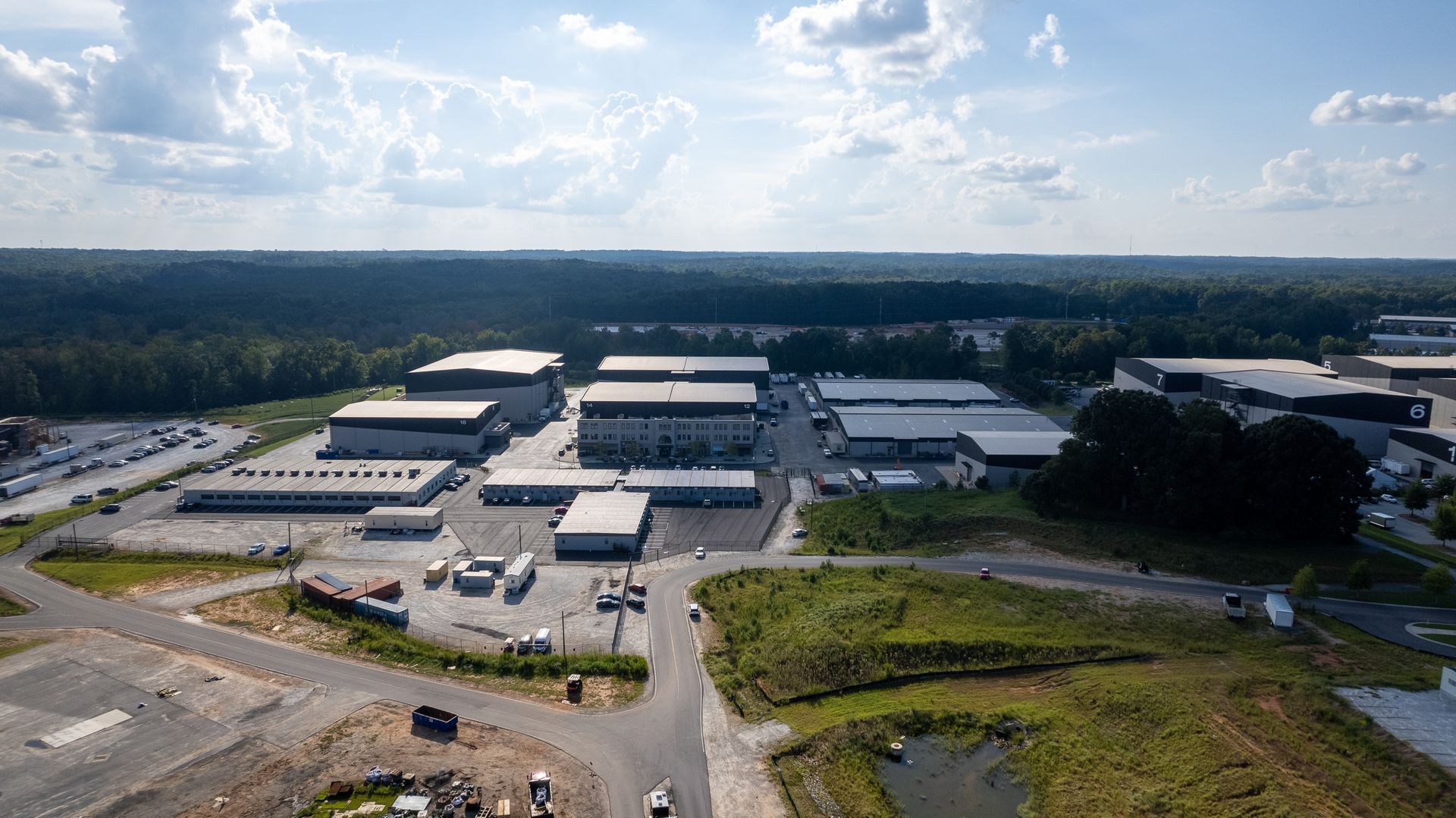 An aerial view of a large industrial area with lots of buildings and trees.