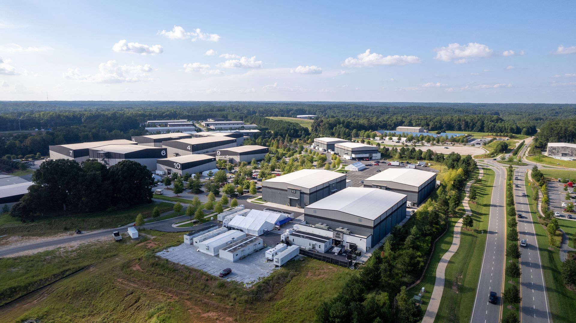 An aerial view of a large industrial area with lots of buildings and trees.