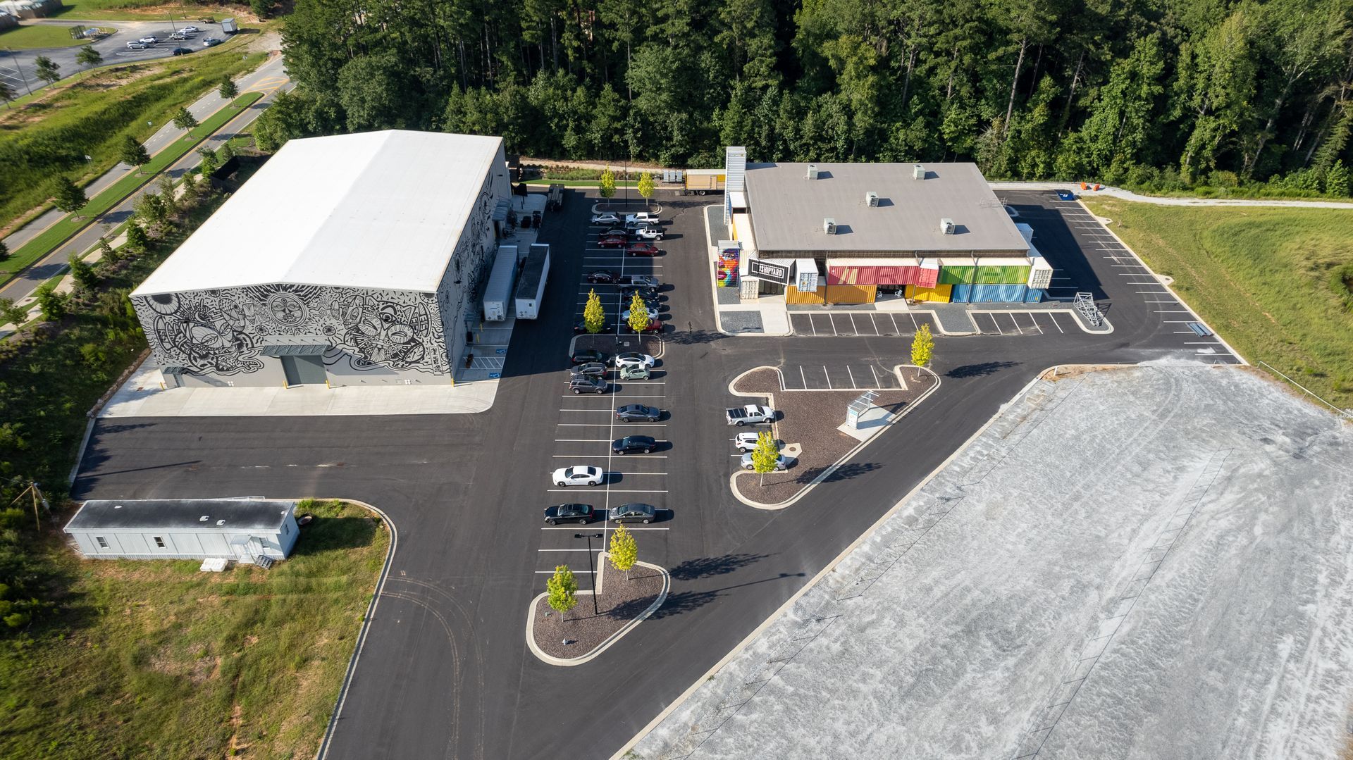 An aerial view of a building and a parking lot