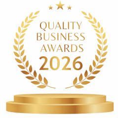 Gold laurel wreath around “Quality Business Awards 2026” with a gold podium