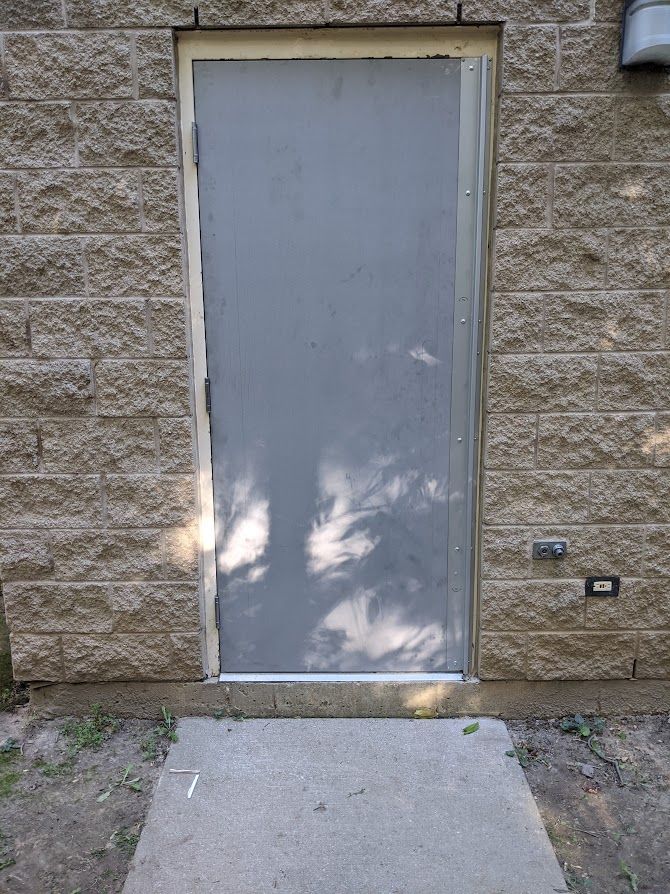 a brick wall with a door that is closed