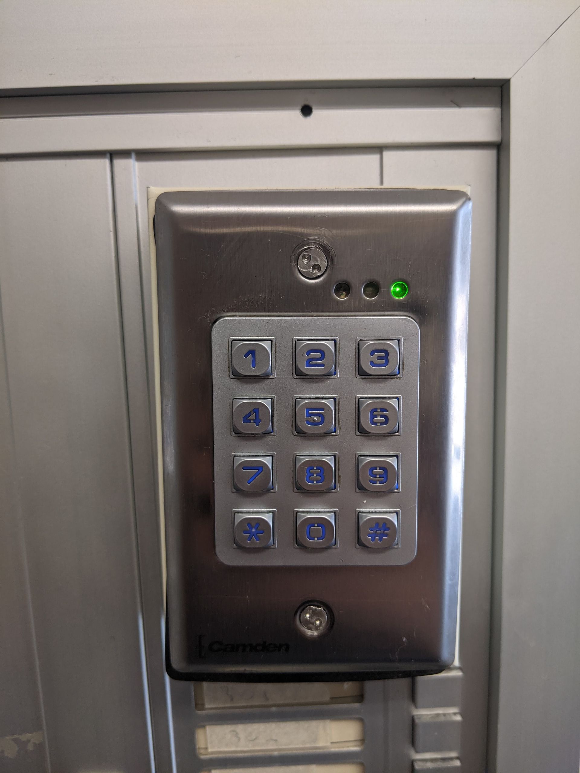 A close up of a keypad on a wall.