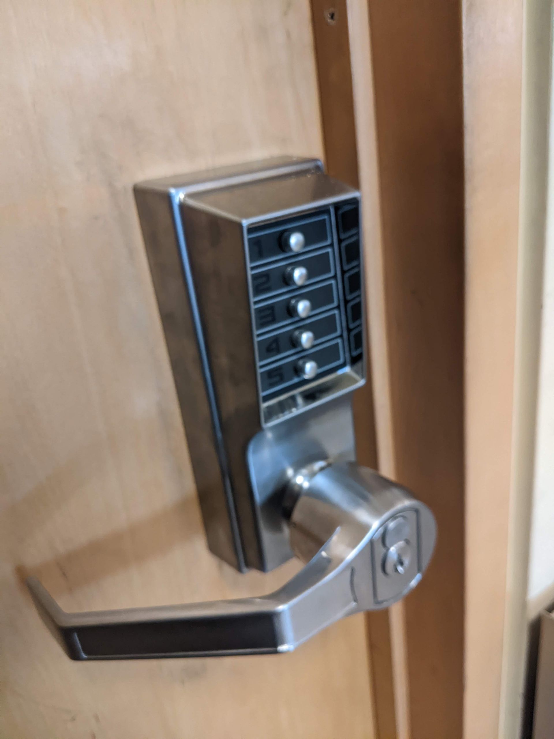 A close up of a door lock on a wooden door