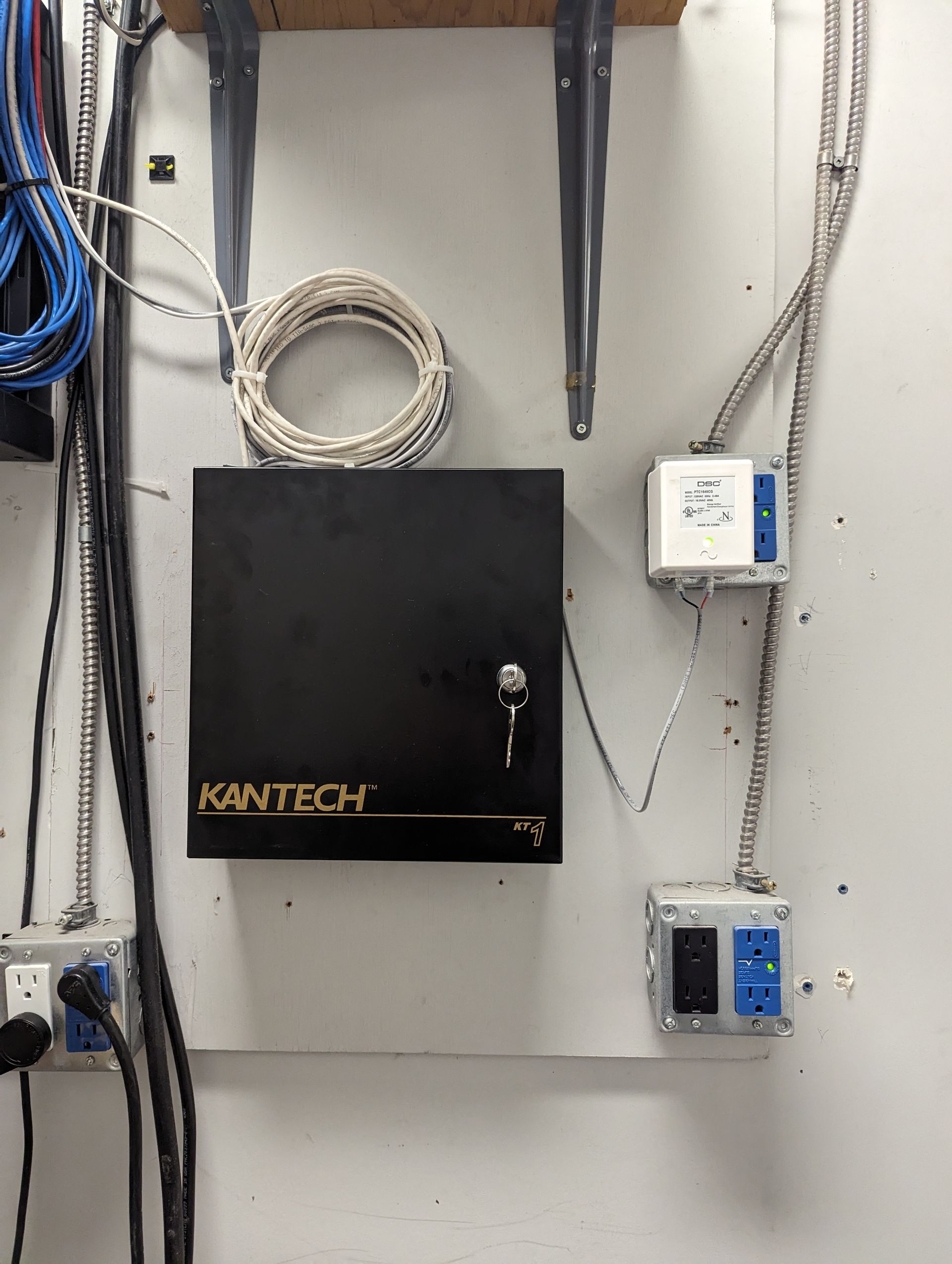 A kantech box is hanging on a white wall