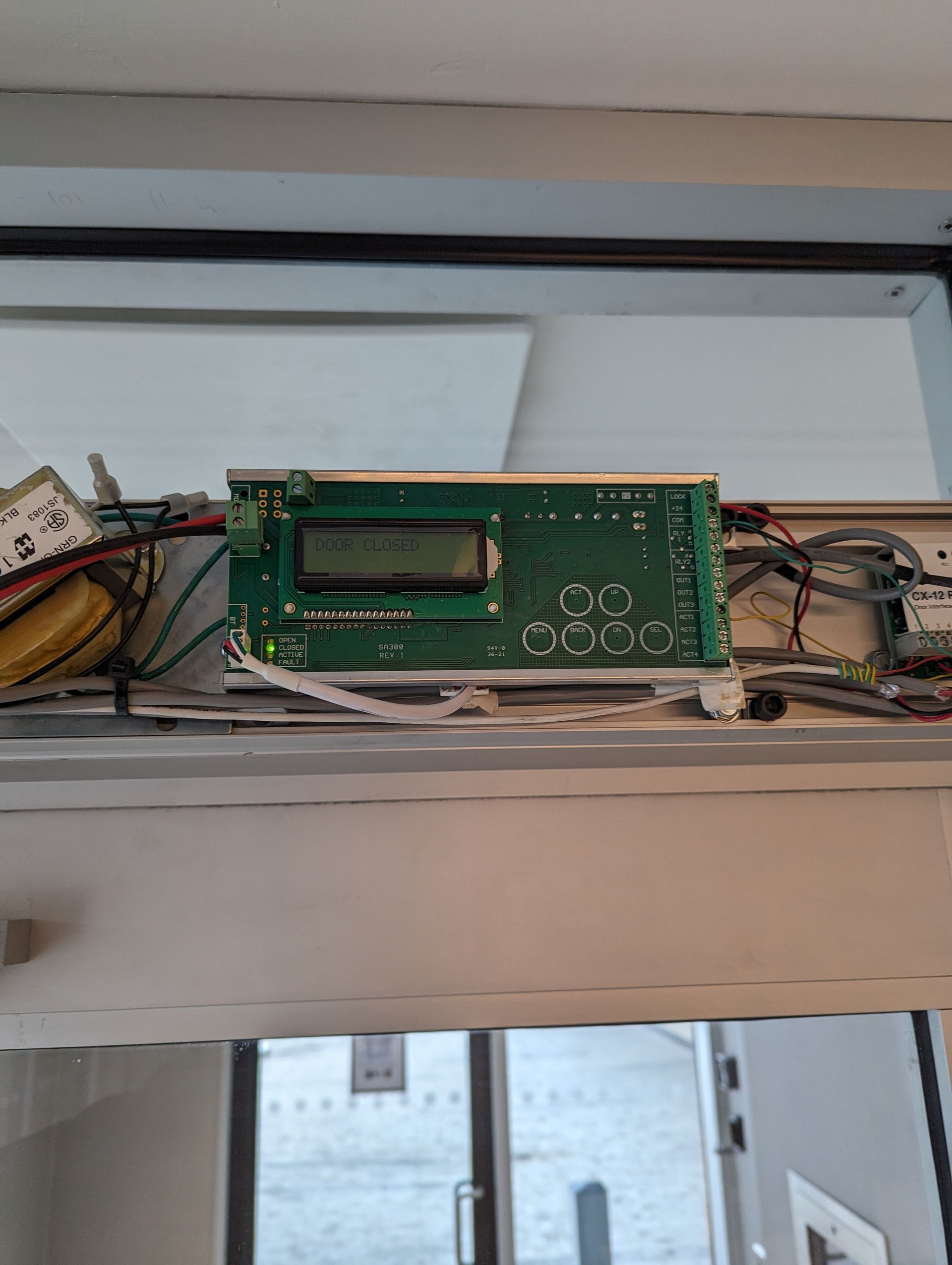 A close up of a electronic device sitting on top of a door.