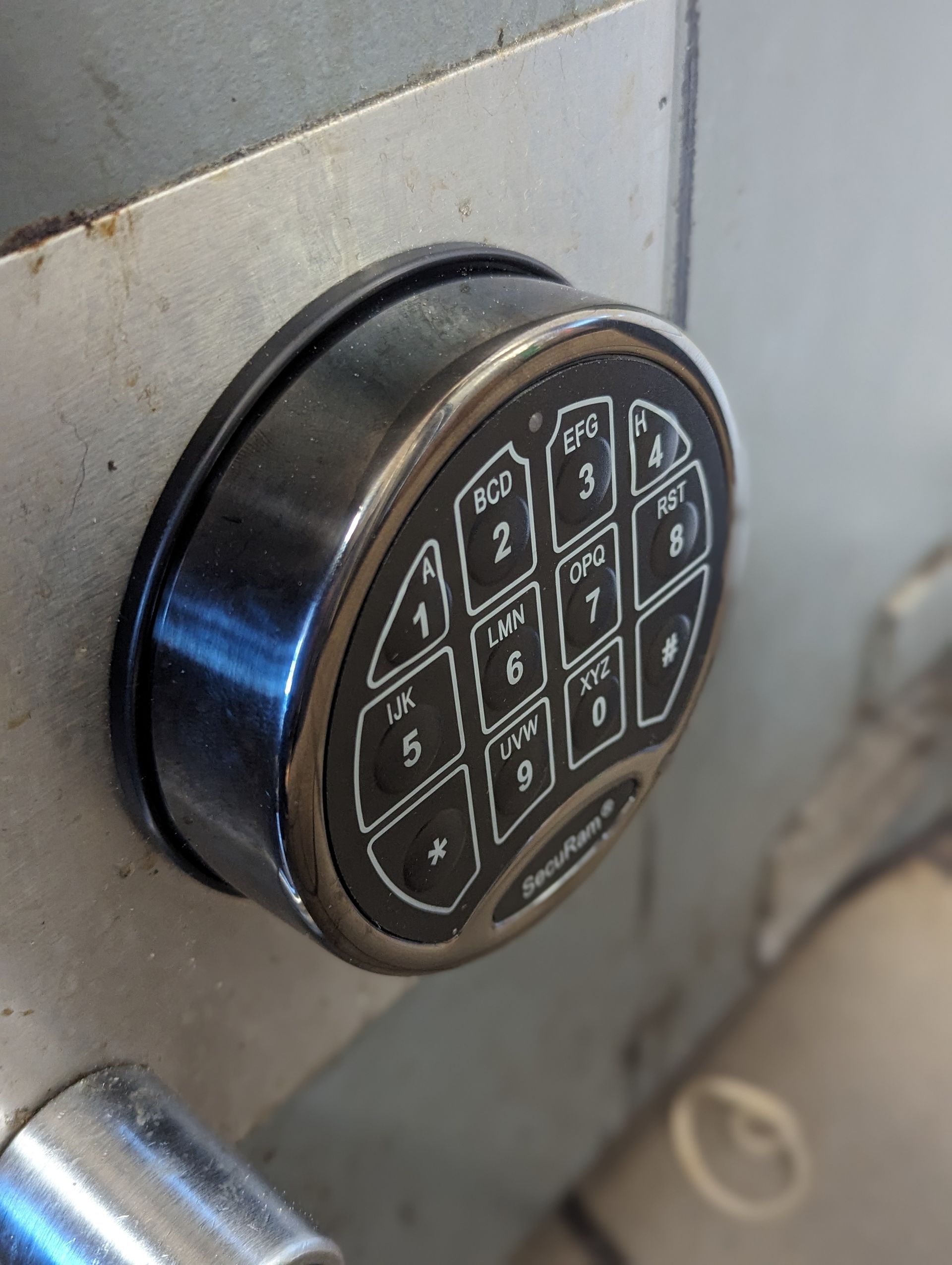 A close up of a keypad on a safe door.