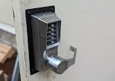 A close up of a door lock on a white door.