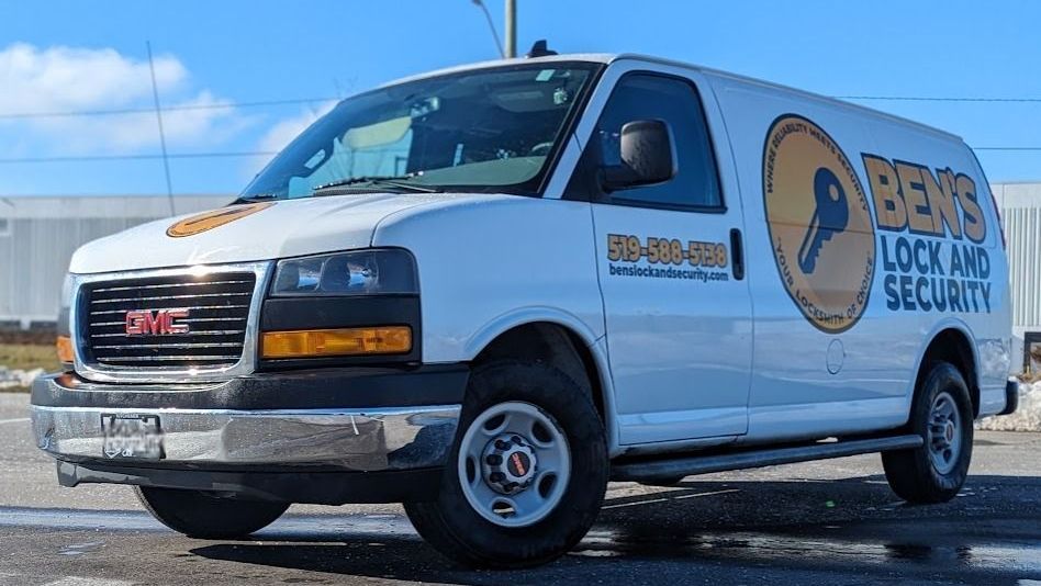 White GMC security van parked outdoors with “Benns Lock & Security” branding on the side