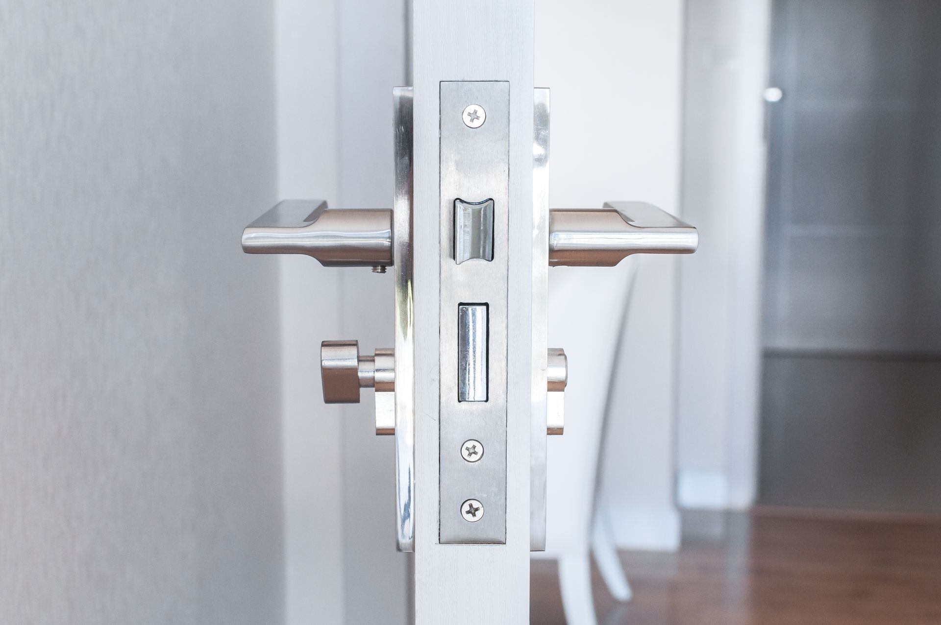 a close up of a door lock on a white door