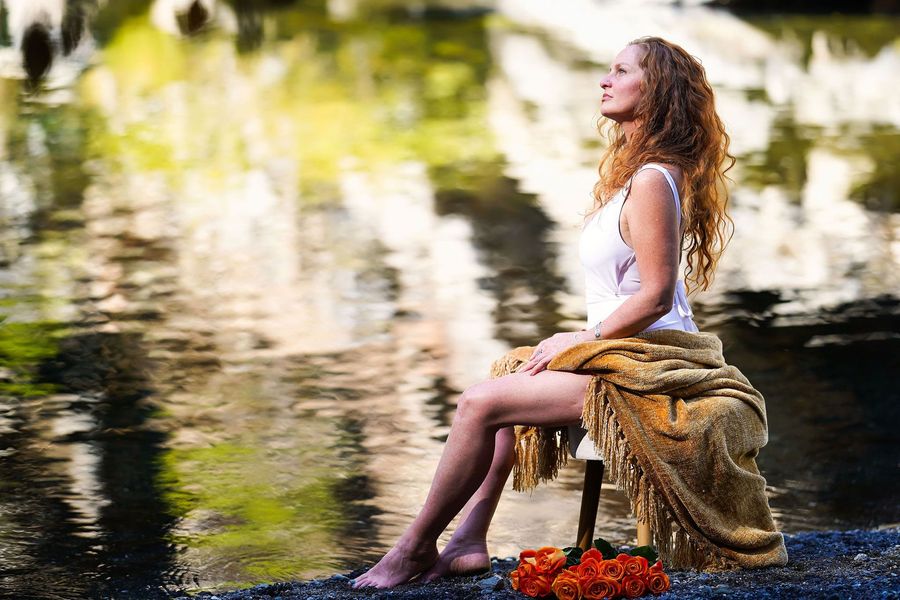 Portrait of Dr. Sky Asher outdoors near old stone and greenery