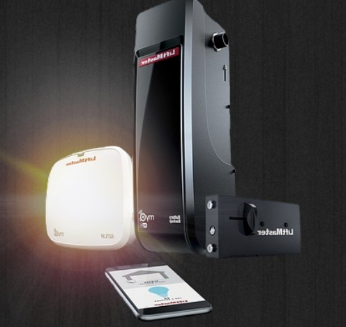 White and black electronic devices displayed on a dark background with a smartphone in front.
