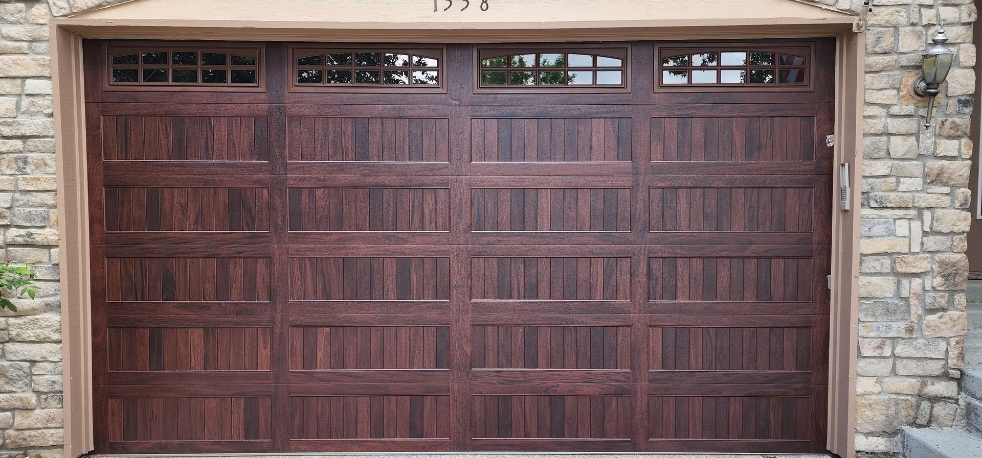 16x10 Accent wood tone Mahogany from CHI, Carriage stamped installed by Aeonic Garage Doors in Broomfield Colorado