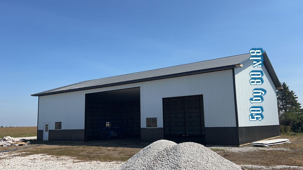White and black metal barn under a blue sky, text reads 50 by 80 by 18.