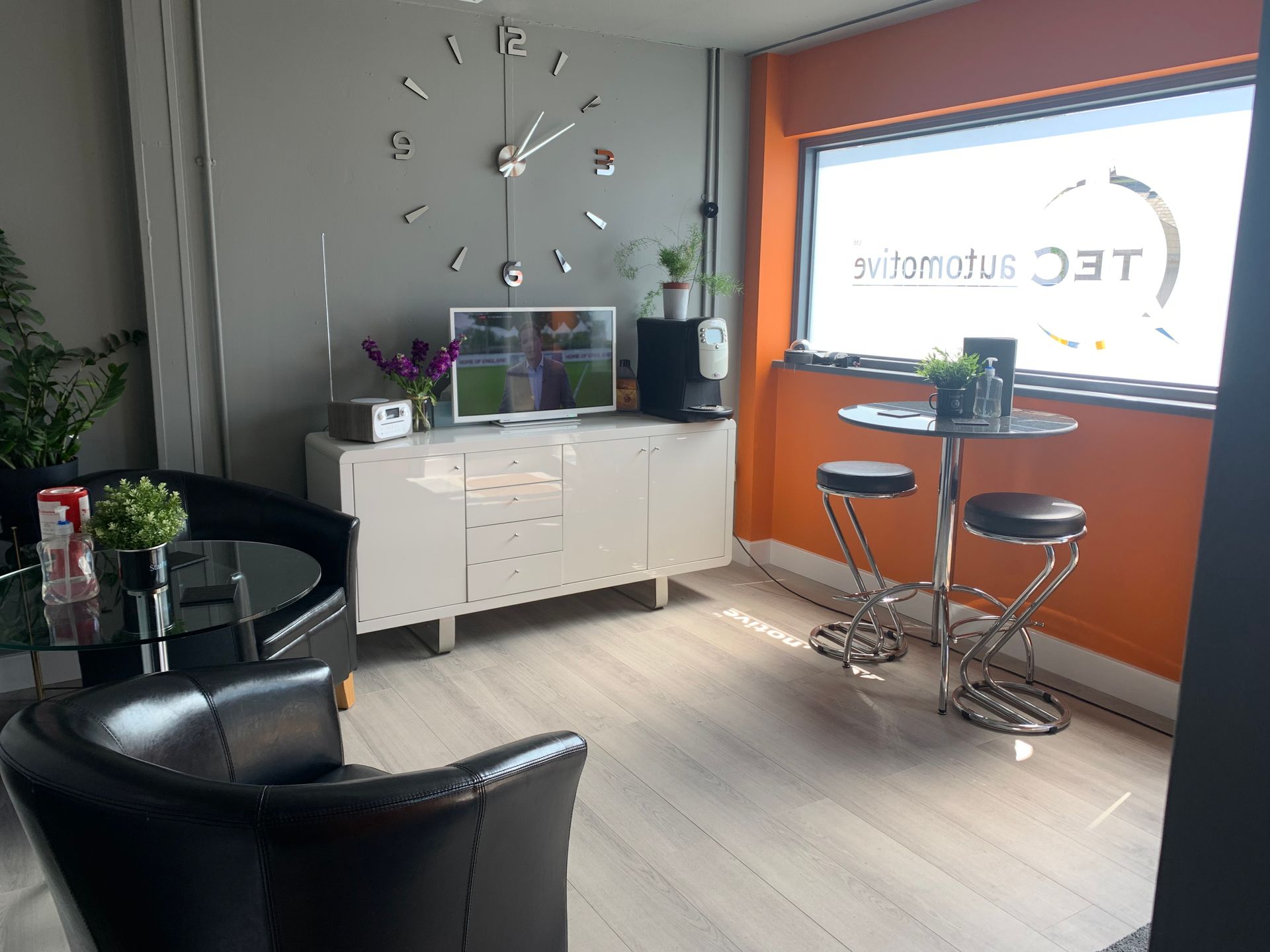 A living room with a large clock on the wall