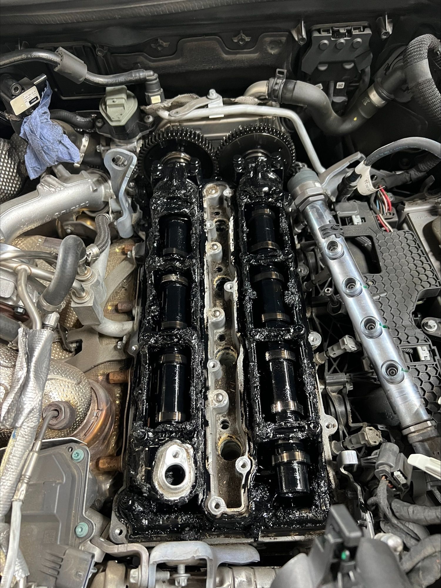 A close up of a car engine with the cover off.