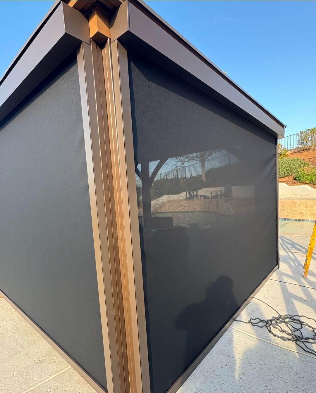 Motorized outdoor patio screens installed on a covered residential patio