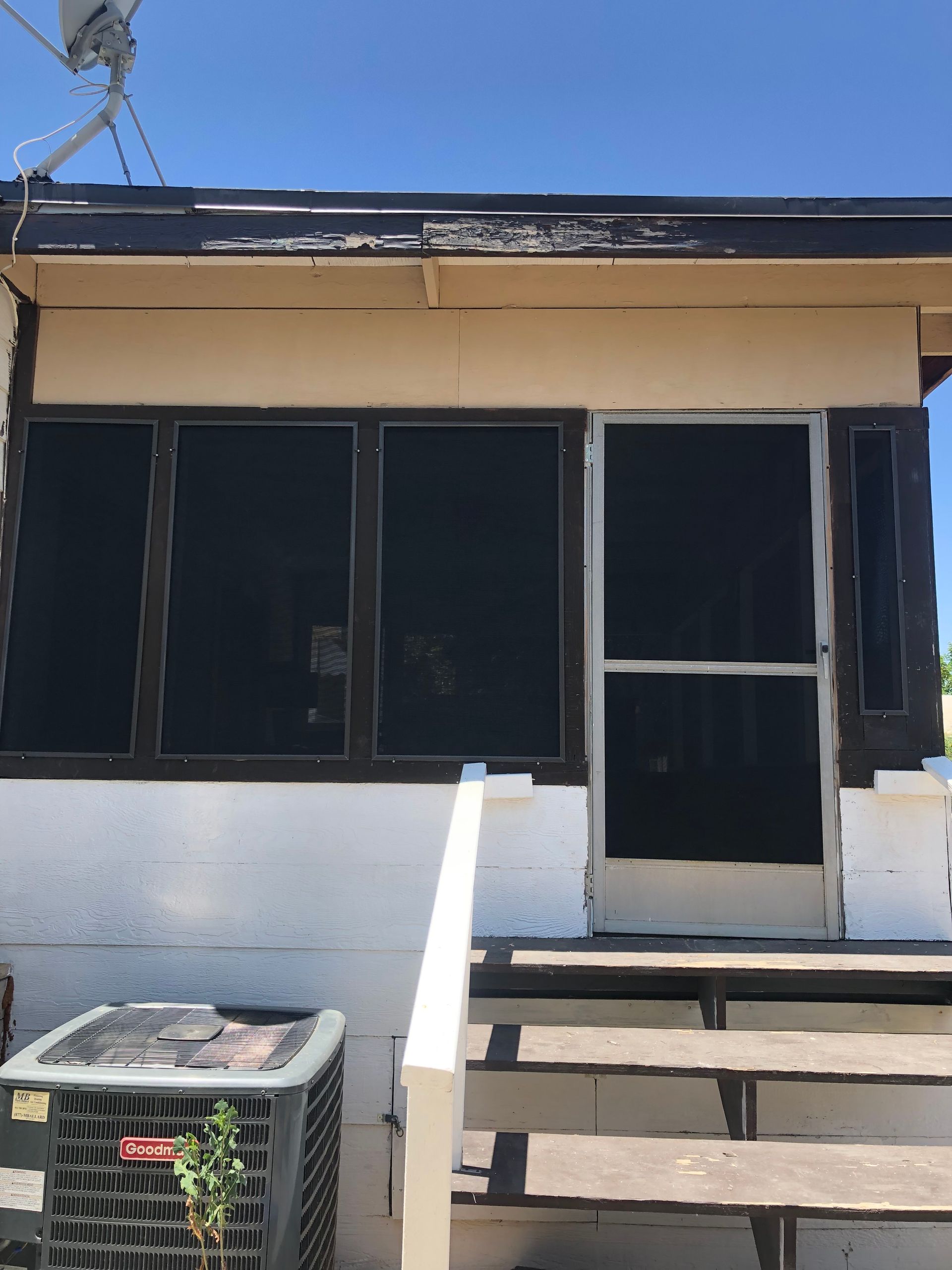 Back patio with sliding screen door and solar screen panels installed