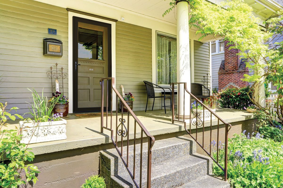 Front porch with railing and a screen door leading into the home