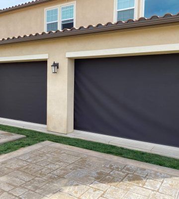 Motorized solar screens reducing sunlight on a outdoor living space or garage area