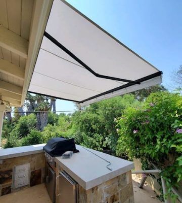 Electric retractable patio awning extended for outdoor shade