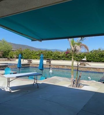 Retractable outdoor awning providing shade over a residential patio