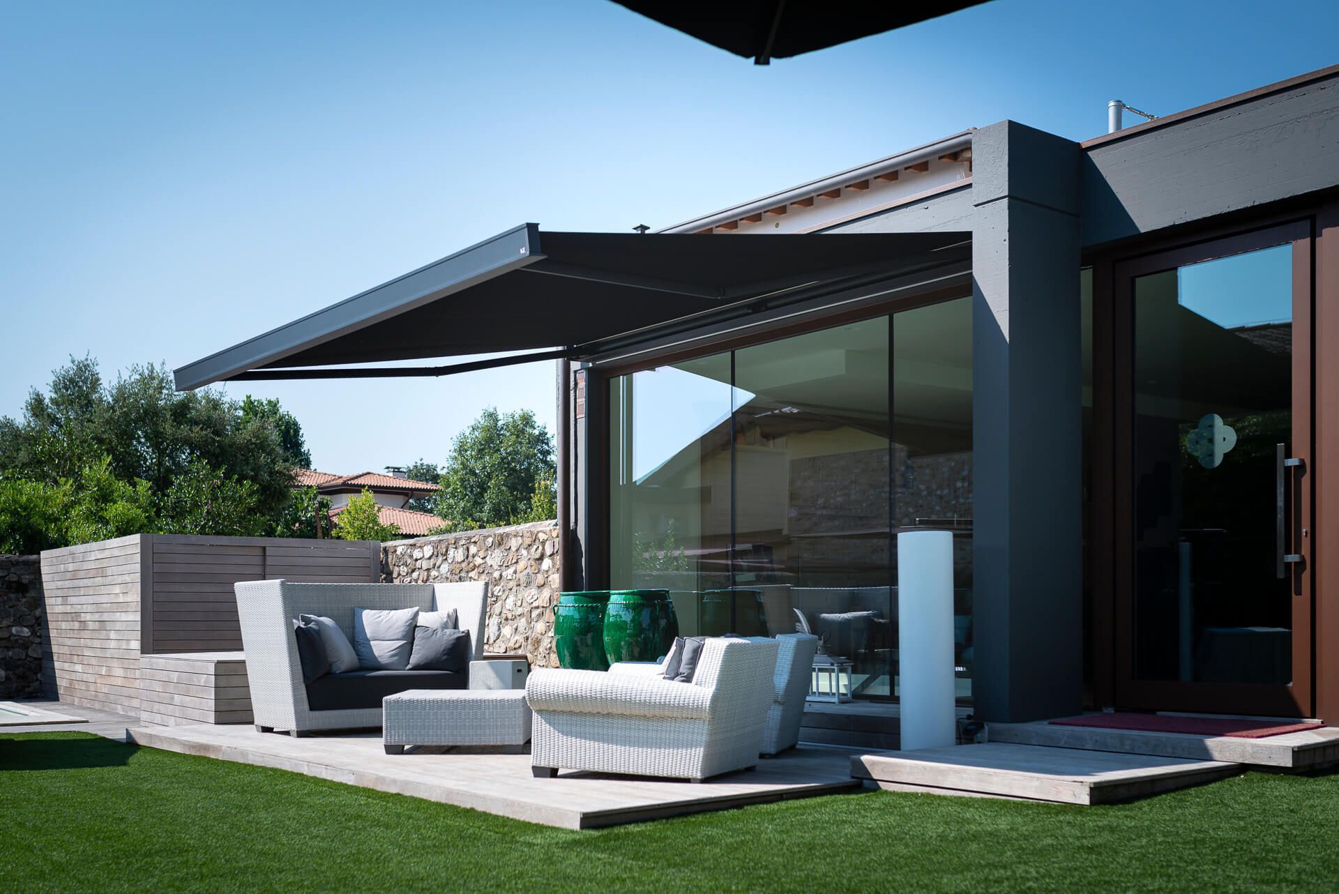 Motorized patio awning with premium fabric extended for shade