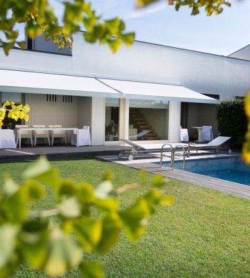 Motorized retractable awning providing shade over a residential patio