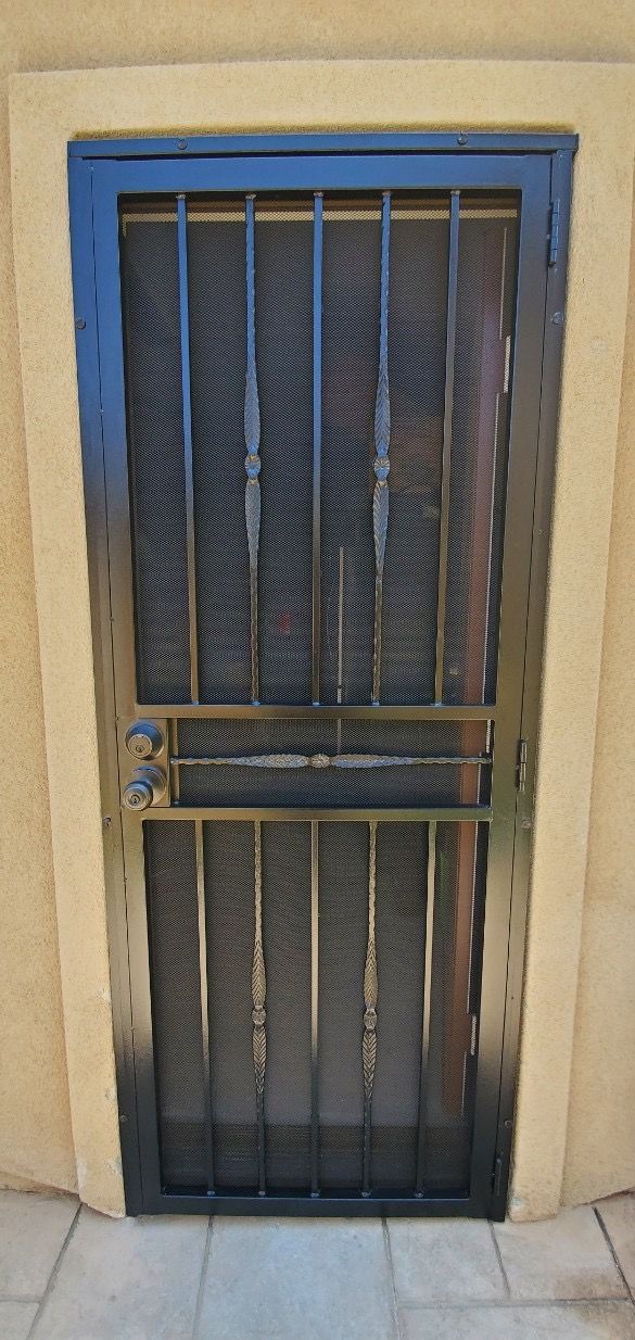 Front entry with a black security screen door and vertical bars