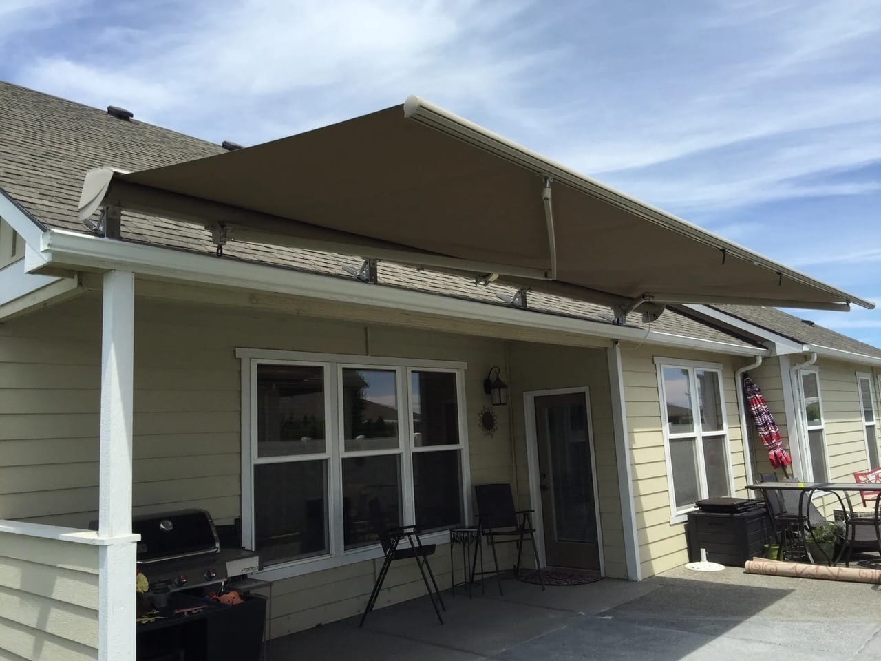 Roof mount motorized retractable awning installed for shade on front porch