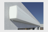Cassette style motorized retractable awning retracted against exterior wall