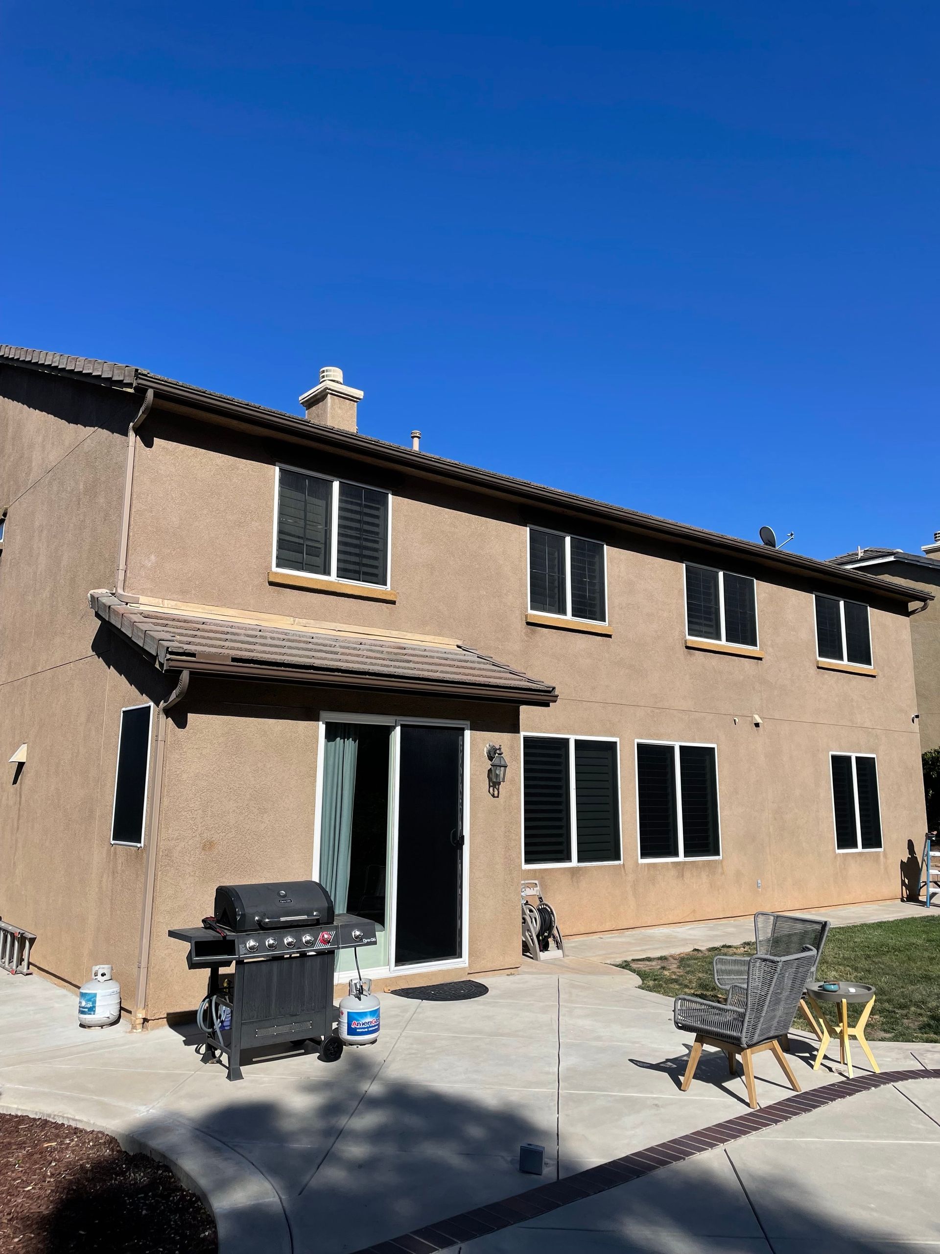 Exterior of a multi-unit residential building with several screened windows
