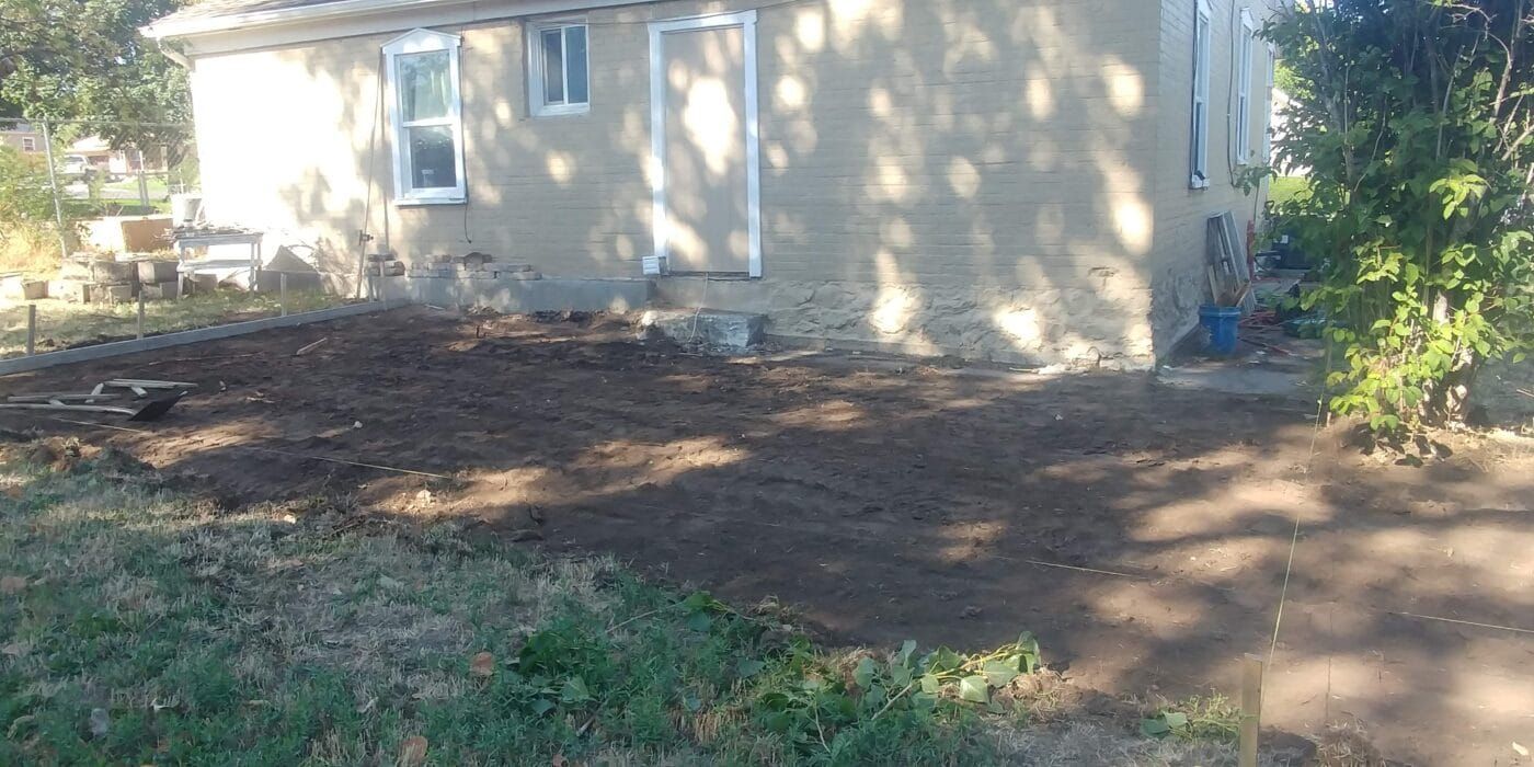 A house with a lot of dirt in front of it.