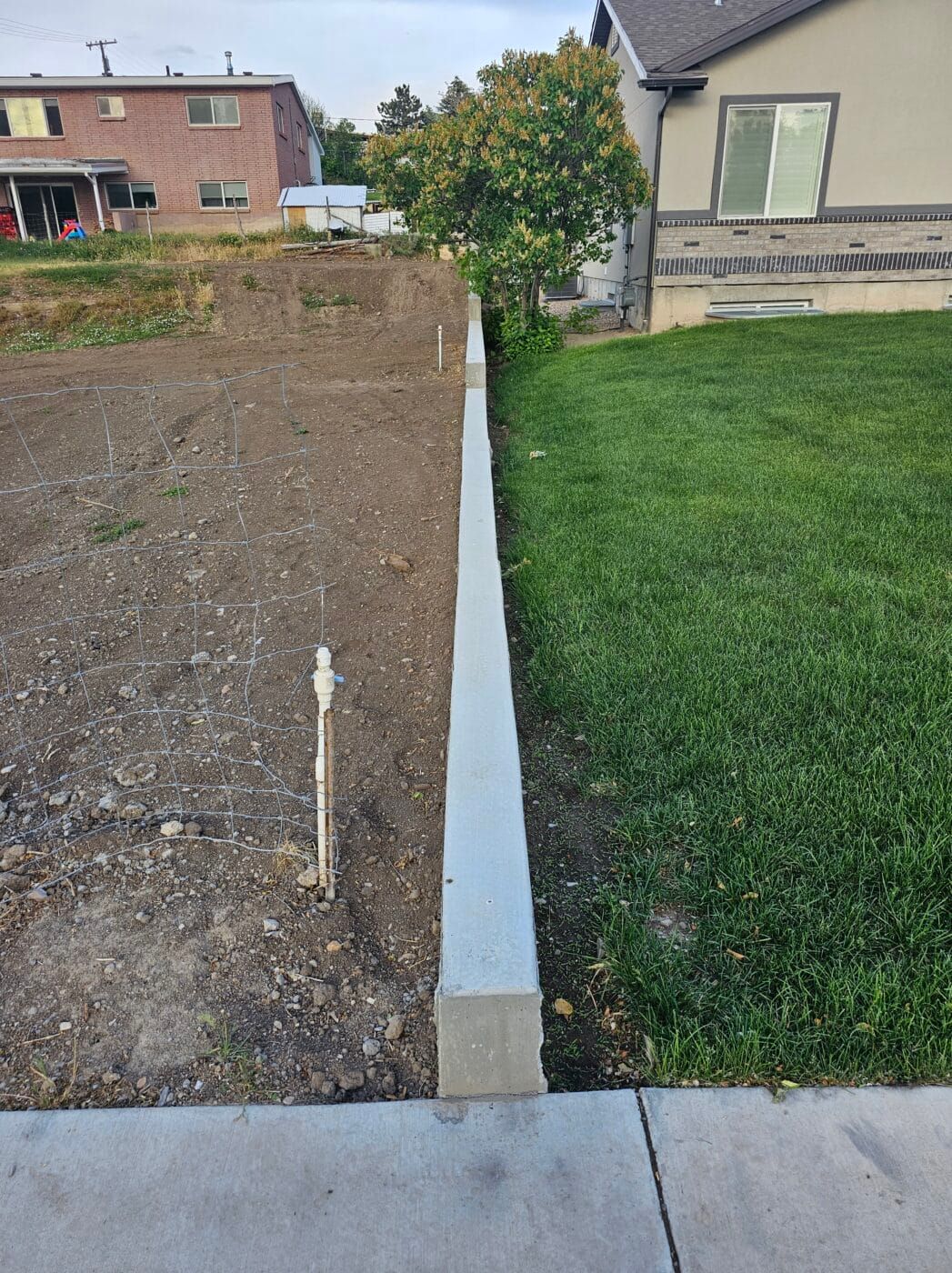 A concrete fence is being built in front of a house.