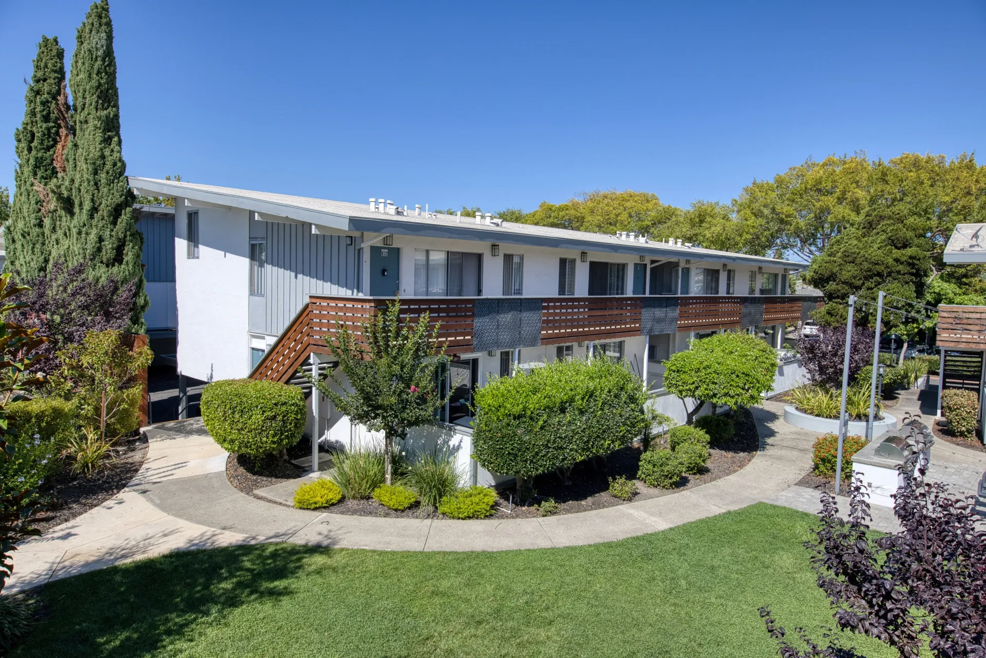 Exterior of a multifamily property with a balcony and walkways.