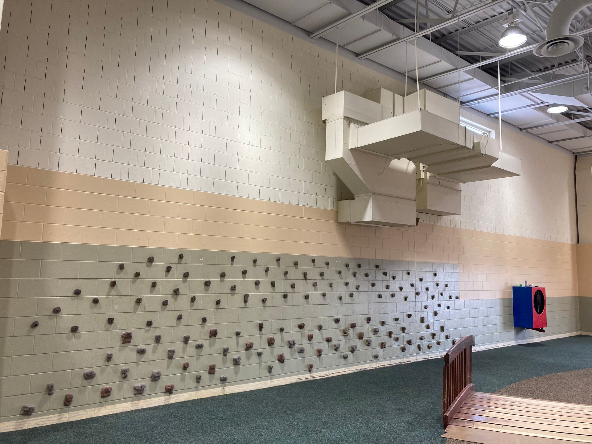 A room with a lot of ducts hanging from the ceiling
