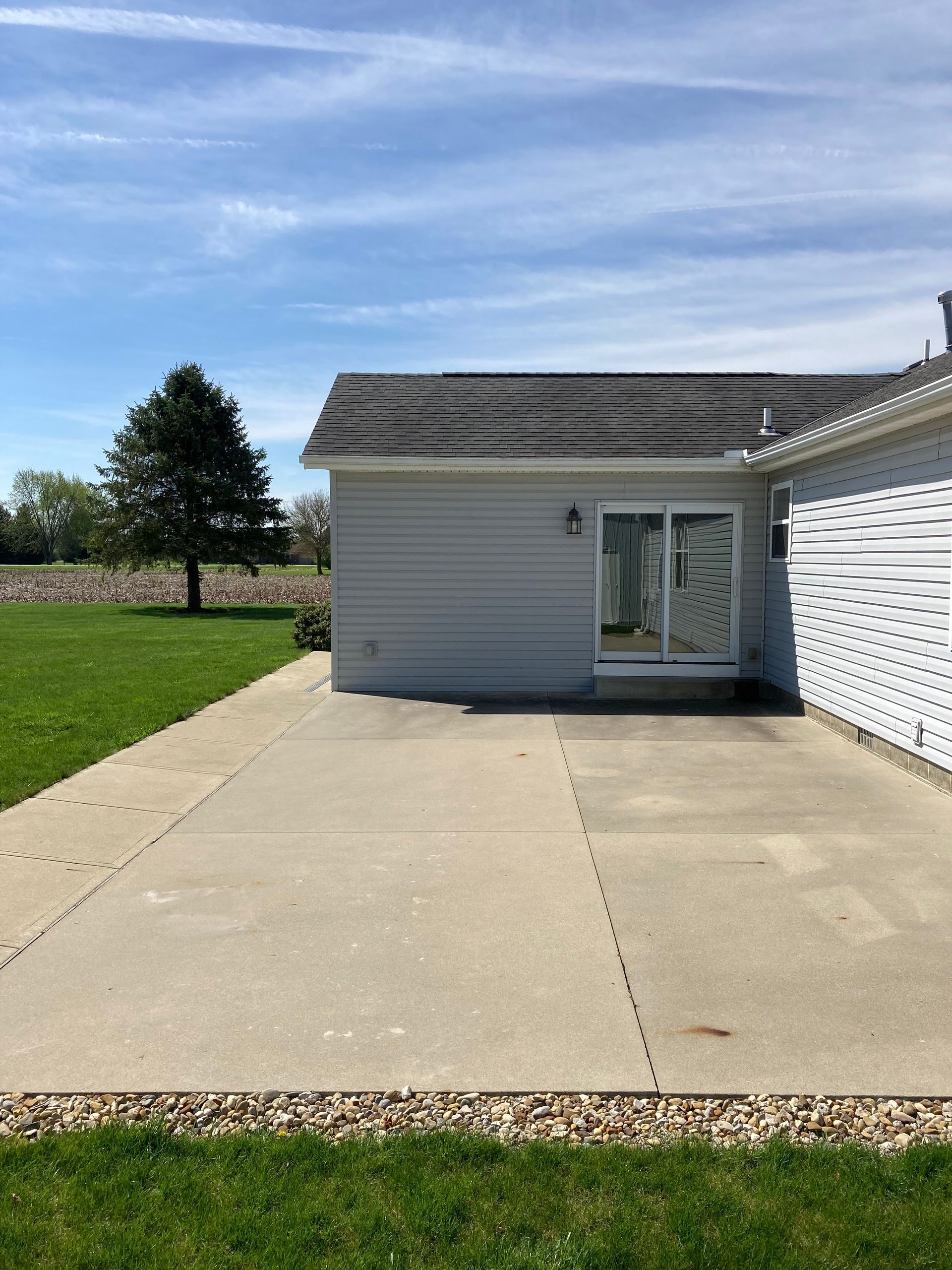 A house with a concrete driveway leading to it