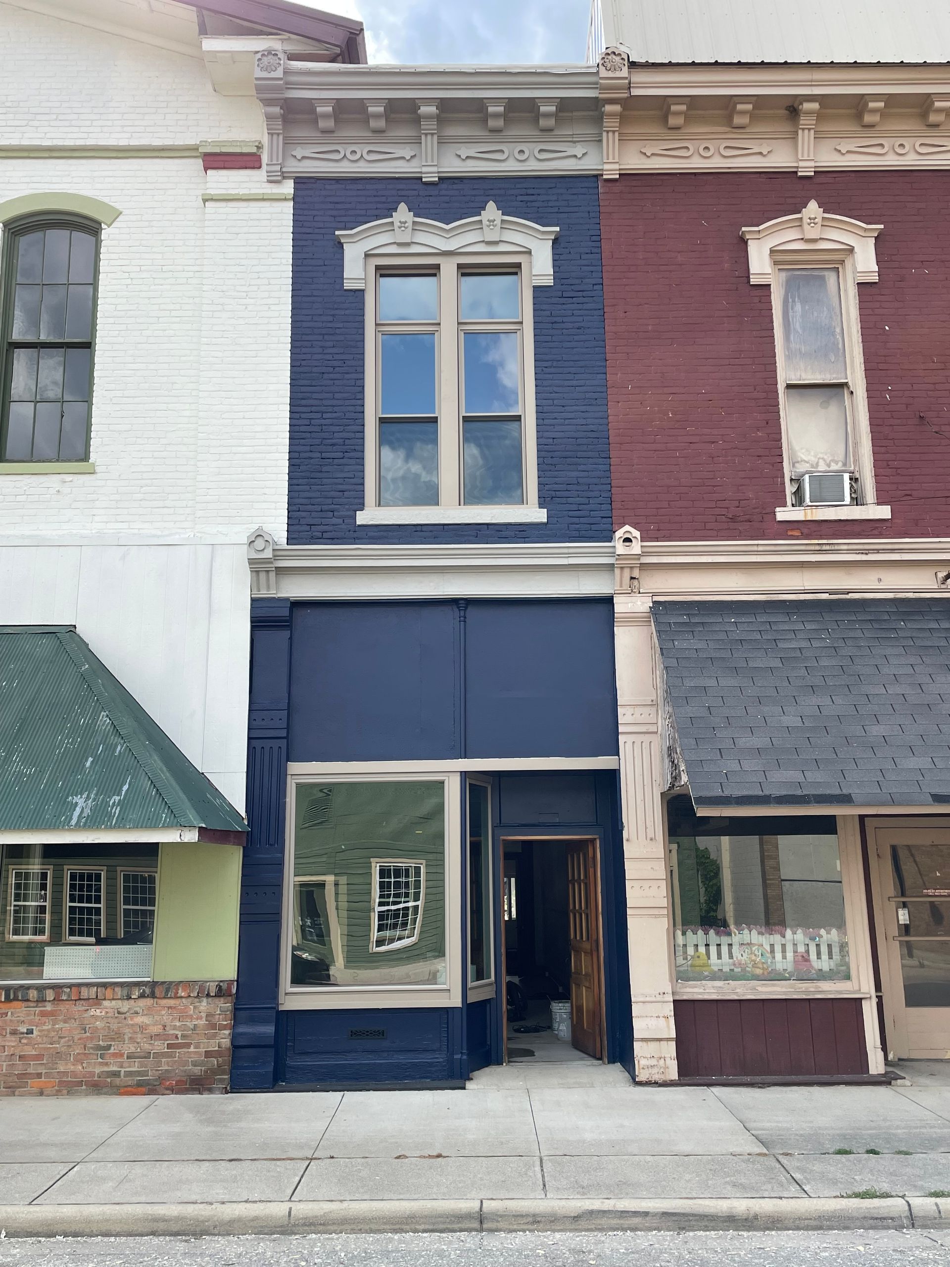 A row of buildings with a blue building in the middle