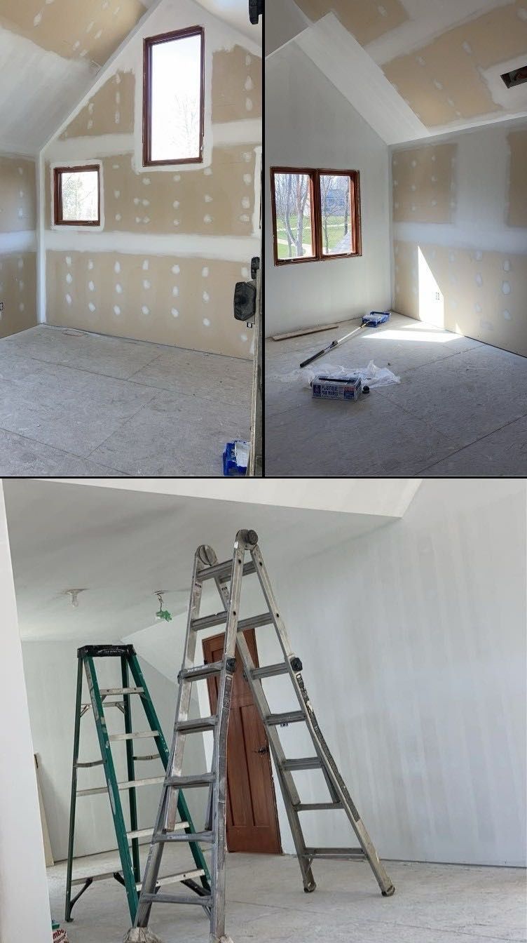 A room with a wooden door and a white ceiling.