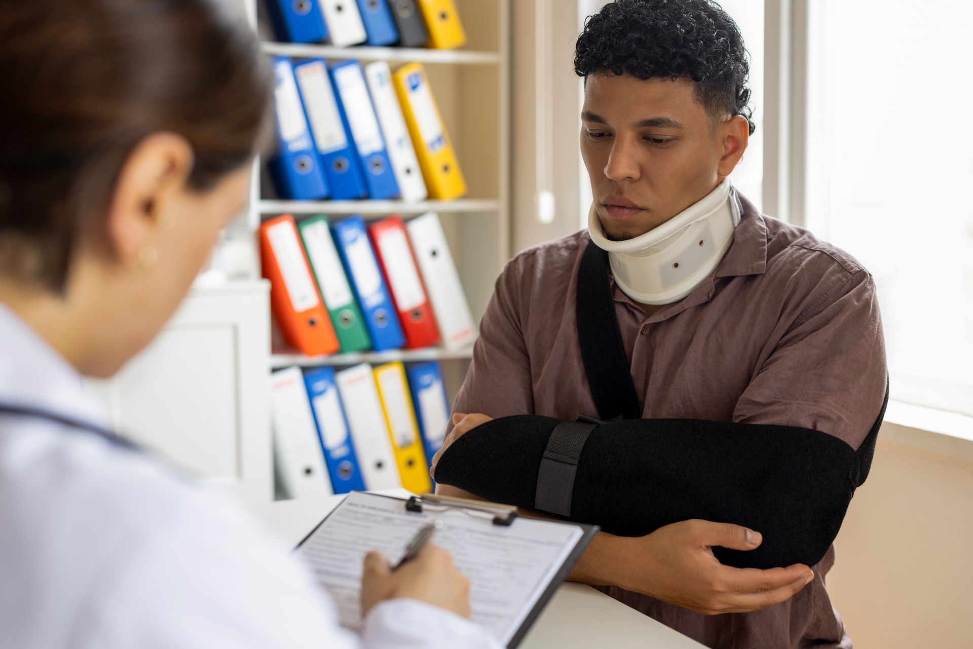An injured man is talking with a woman.