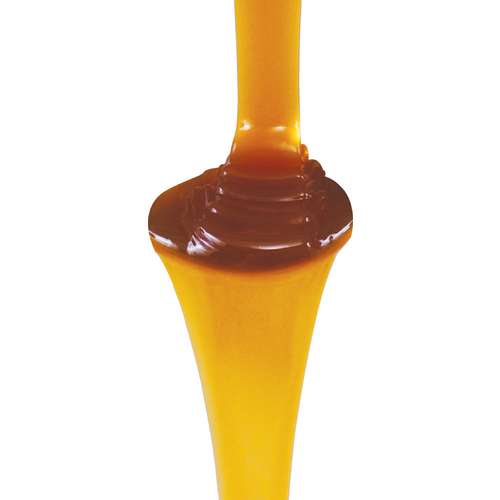 Caramel sauce pouring down; golden and brown colors, smooth texture.