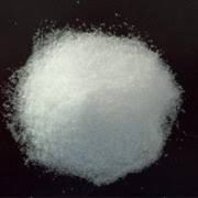 A pile of white powder on a black surface.