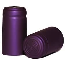 Two purple plastic wine bottle caps are sitting next to each other on a white background.