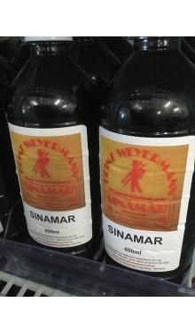 Two bottles of sinamar are sitting on a shelf.