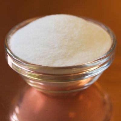 A glass bowl filled with white powder on a table