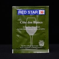 A packet of red star cote des blancs wine yeast is sitting on a table.