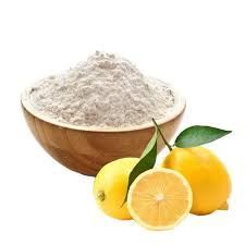 A bowl of powder next to lemons on a white background.